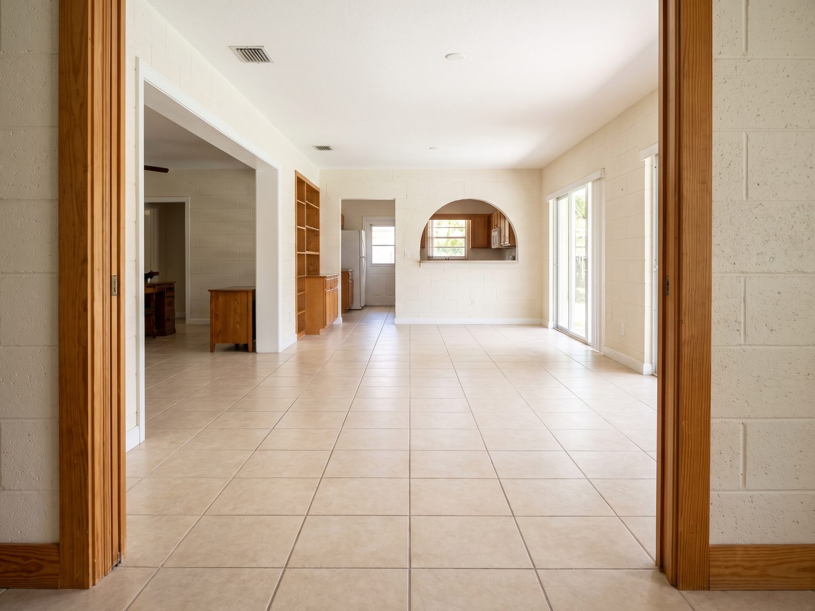 Documenting Contiguous Flooring | Restoration Doctor Wide view along an unbroken tile floor plane running through three connected rooms of a Miami house.
