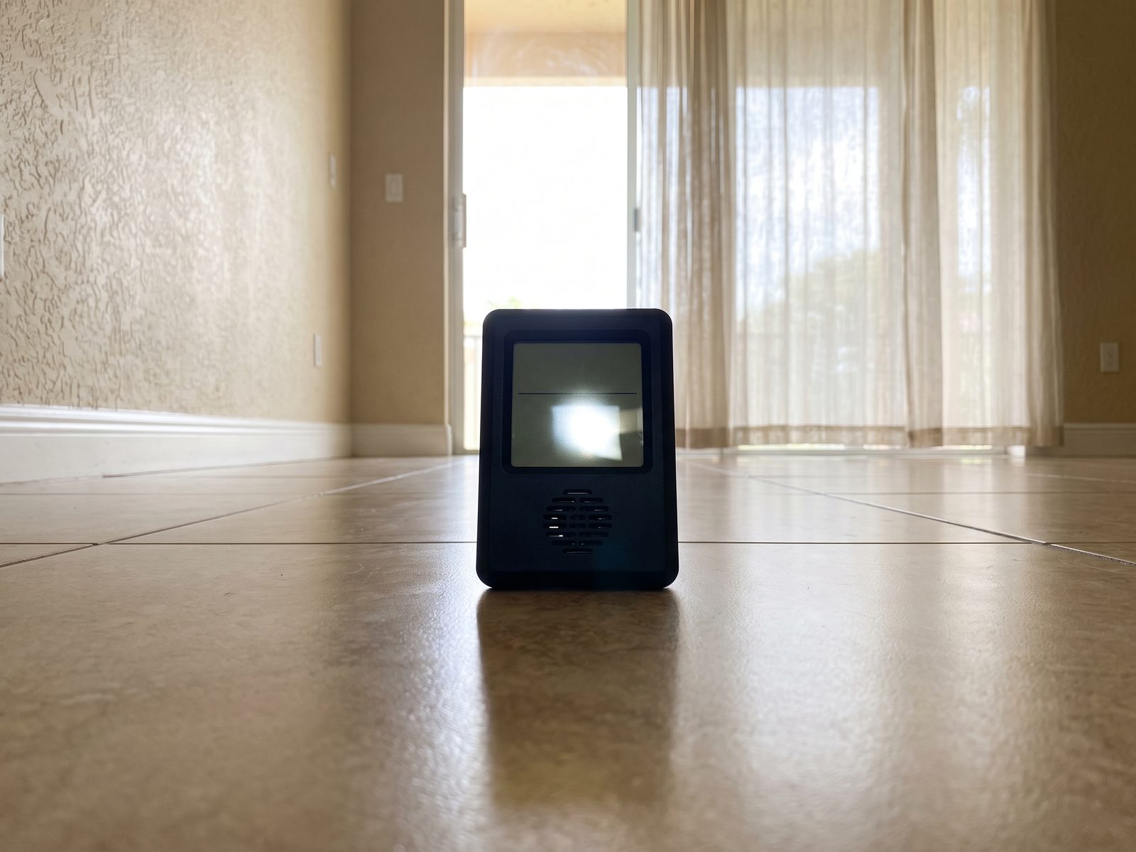 Ambient Humidity Reading Florida | Restoration Doctor Digital thermo-hygrometer standing on the tile floor of a sunlit South Florida room.