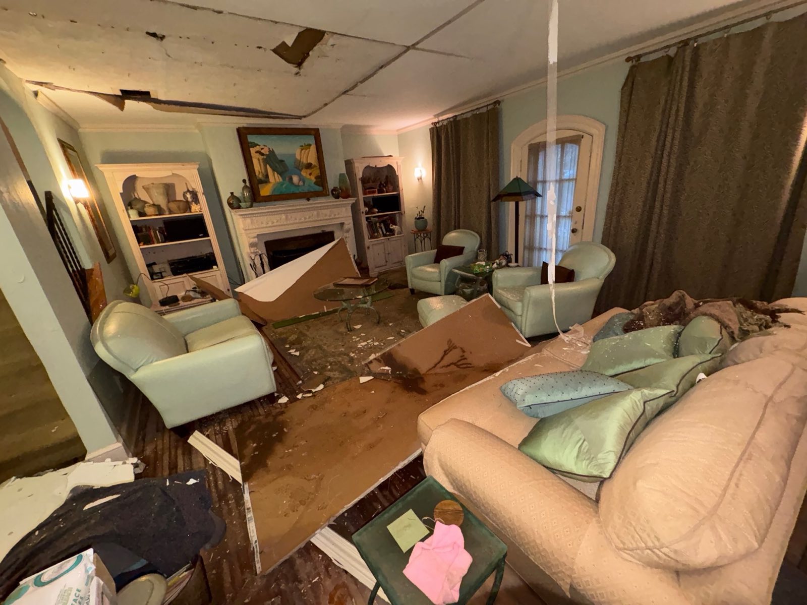 Storm-damaged living room with collapsed ceiling before restoration — Restoration Doctor emergency response